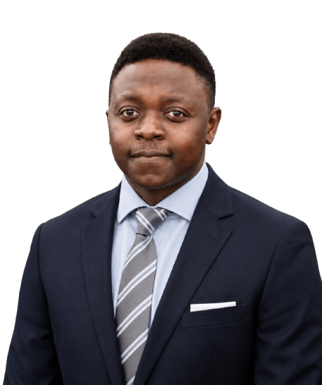 Professional portrait of a man in a navy suit, light blue shirt, striped gray tie, and white pocket square.