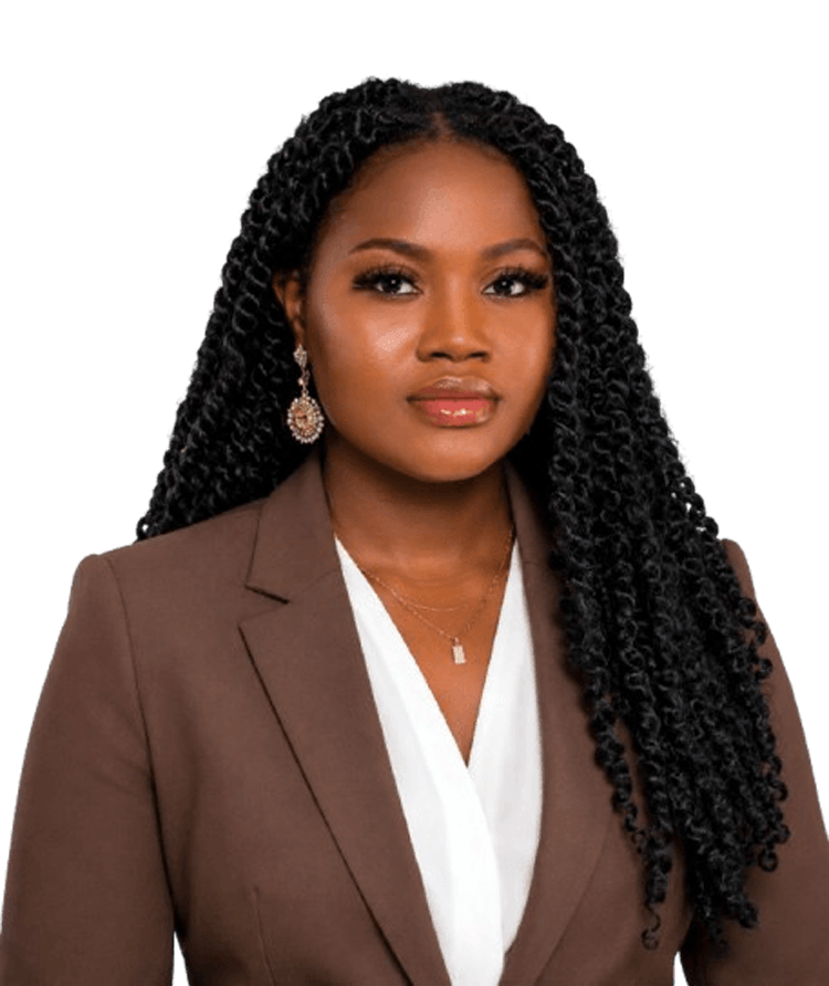 Professional portrait of a Black woman with long twisted hair, wearing a brown blazer and white blouse.