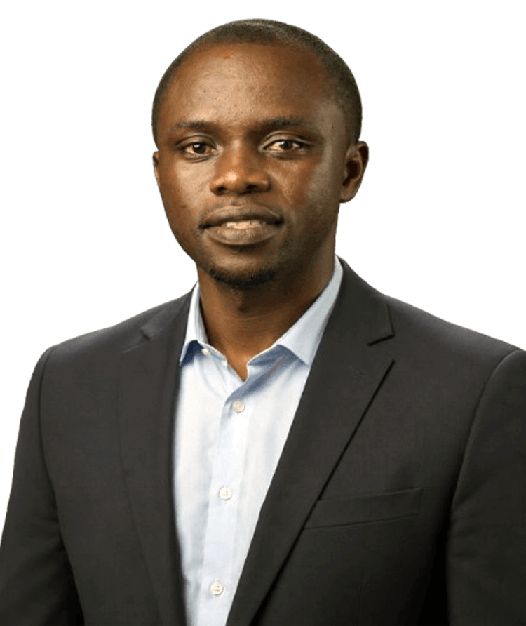 Professional head-and-shoulders portrait of a man in a dark suit and light blue shirt, looking at the camera.